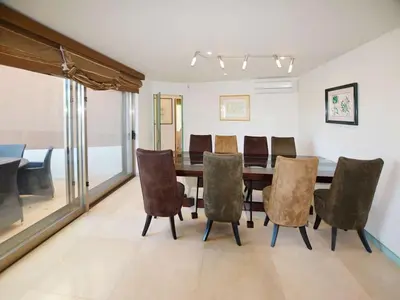 a dining room with a table and chairs at Special Vilamoura Villa 6 Bedrooms Villa Lagoon Private Pool in Quarteira
