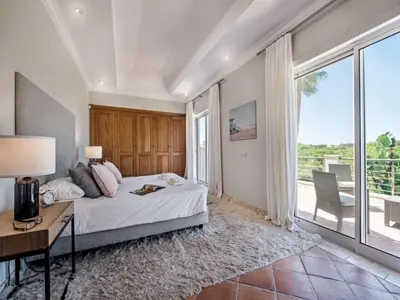 a bedroom with a bed and a desk and a window at Amazing Algarve Villa 5 Bedrooms Villa Lillian Private Pool & Ping Pong in Almancil
