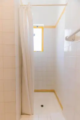 a bathroom with a shower with a shower curtain at AL - Aldeia do Golfe Retreat in Vilamoura