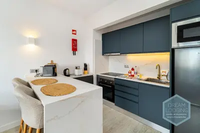 a small apartment with a table and a bed at Moai - Dream Lodging in Albufeira
