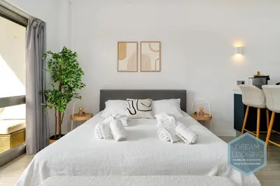 a living room with a bed and a dining room at Moai - Dream Lodging in Albufeira