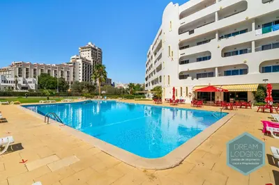 a large swimming pool in front of a building at Moai - Dream Lodging in Albufeira