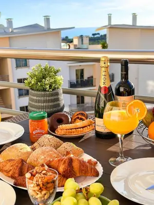 a table topped with plates of food and bottles of wine at AlbufeiraOrada Cozy&Sunny Condo by BeCherish in Albufeira
