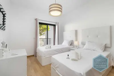 a white room with two beds and a sink at Miguel Torga - Dream Lodging in Albufeira