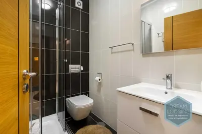 a bathroom with a shower and a toilet and a sink at Miguel Torga - Dream Lodging in Albufeira