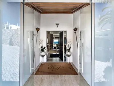 a hallway with glass doors leading into a room at Outstanding Algarve Villa 8 Bedrooms Villa Agua Grande Deluxe Seaviews in Albufeira
