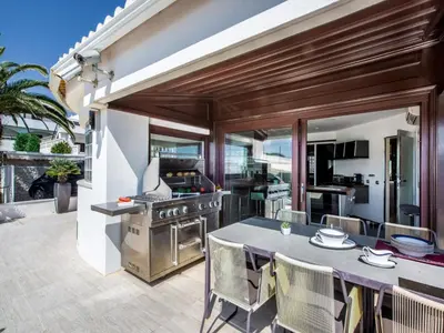 a kitchen and dining room with a table and a grill at Outstanding Algarve Villa 8 Bedrooms Villa Agua Grande Deluxe Seaviews in Albufeira