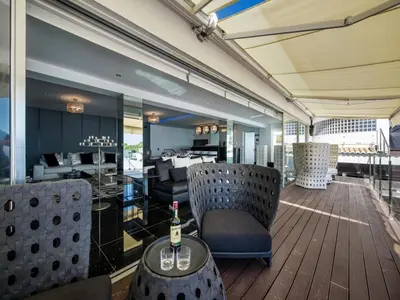 a room with chairs and a table with a bottle of wine at Outstanding Algarve Villa 8 Bedrooms Villa Agua Grande Deluxe Seaviews in Albufeira