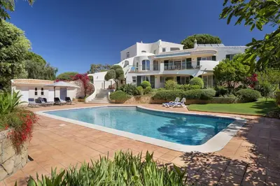 a bathroom with two sinks and a shower and a mirror at Extravagant Vale Do Lobo Villa 5 Bedrooms Villa Bispo Deluxe Great Pool in Almancil