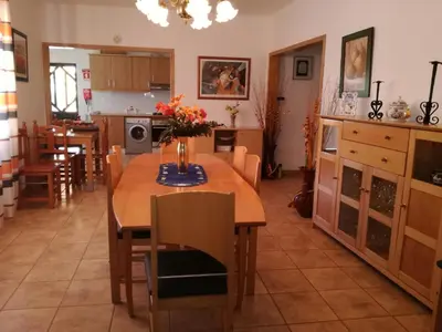 a kitchen and dining room with a table and chairs at Quinta Vita - Vila Limao in Almancil