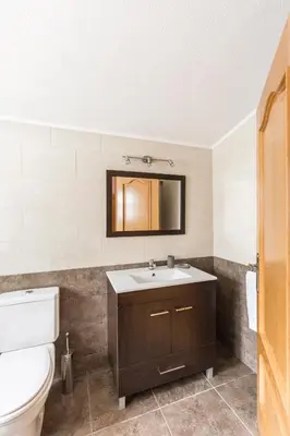 a bathroom with a sink and a toilet at Quinta Vita - Vila Limao in Almancil