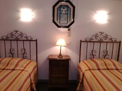 a room with two beds and a lamp on a table at Quinta Vita - Vila Limao in Almancil