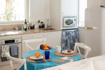 a kitchen with a table with fruit on it at Casa Passion in Faro