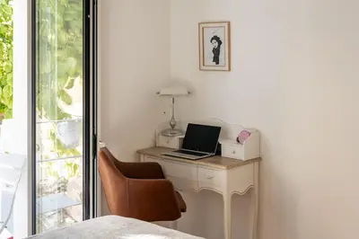 a bedroom with a desk with a laptop and a chair at Casa Passion in Faro