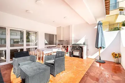 an open living room with chairs and a table at BeGuest Falésia Beach & Barbecue Apartment in Albufeira
