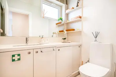a bathroom with a toilet and a sink and a mirror at BeGuest Falésia Beach & Barbecue Apartment in Albufeira