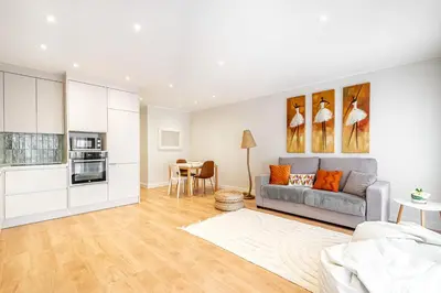 a living room with a couch and a table at BeGuest Falésia Beach & Barbecue Apartment in Albufeira