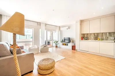 a living room with a couch and a table at BeGuest Falésia Beach & Barbecue Apartment in Albufeira
