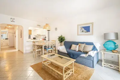 a living room with a blue couch and a table at BeGuest Balaia Apartment 137 in Albufeira