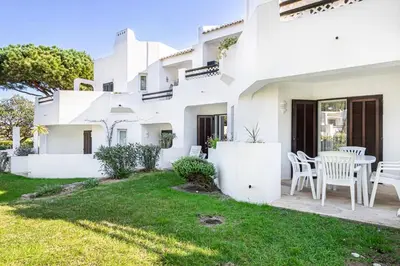 a white house with a lawn in front of it at BeGuest Balaia Apartment 137 in Albufeira