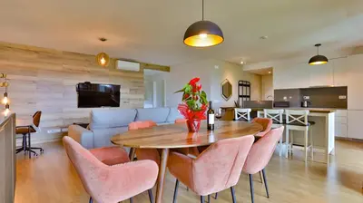 a living room with a table and chairs and a couch at Apartamento T2 novo e espaçoso em Vilamoura in Vilamoura