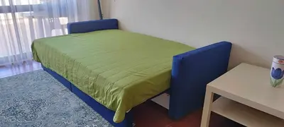 a small bed in a room with a table at Albufeira INN - Lote 6 T1 in Albufeira