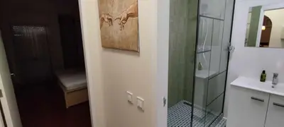 a bathroom with a glass shower and a sink at Albufeira INN - Lote 6 T1 in Albufeira