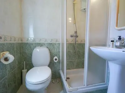 a bathroom with a toilet and a sink and a shower at Oura Sunrise 16 Apartment by Stay ici Algarve Holiday Rental in Albufeira