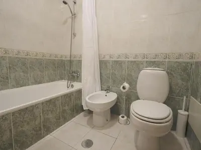 a bathroom with a toilet and a tub and a sink at Oura Sunrise 16 Apartment by Stay ici Algarve Holiday Rental in Albufeira
