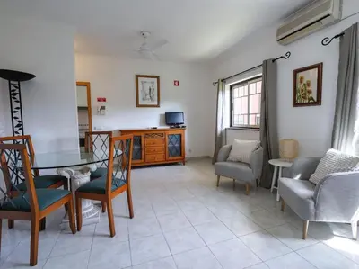 a living room with a table and chairs at Oura Sunrise 16 Apartment by Stay ici Algarve Holiday Rental in Albufeira