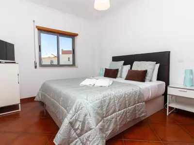 a bedroom with a large bed and a window at Globe 33 Apartment by Stay ici Algarve Holiday Rental in Albufeira