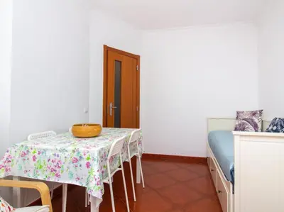 a dining room with a table and a bed at Globe 33 Apartment by Stay ici Algarve Holiday Rental in Albufeira