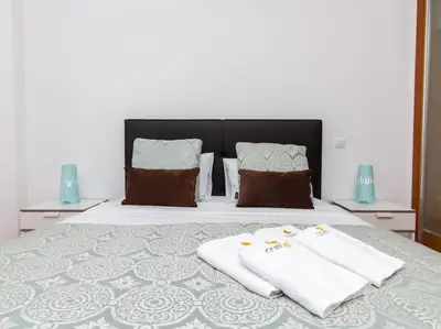 a bedroom with a bed with two towels on it at Globe 33 Apartment by Stay ici Algarve Holiday Rental in Albufeira