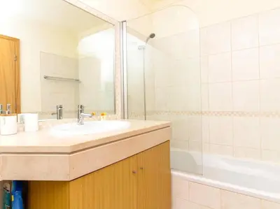 a bathroom with a sink and a shower and a tub at View Waves Apartment by Stay ici Algarve Holiday Rental in Albufeira