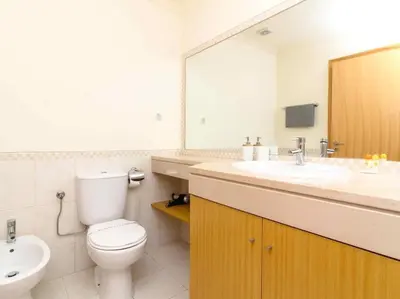 a bathroom with a toilet and a sink and a mirror at View Waves Apartment by Stay ici Algarve Holiday Rental in Albufeira
