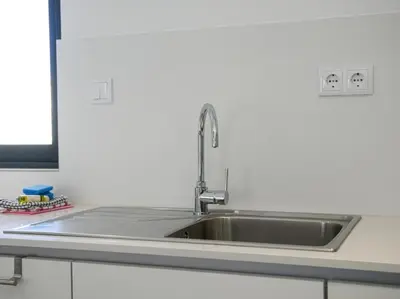 a stainless steel sink in a kitchen at Panoramic E Apartment by Stay ici Algarve Holiday Rental in Albufeira