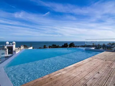 a swimming pool with a view of the ocean at Panoramic E Apartment by Stay ici Algarve Holiday Rental in Albufeira