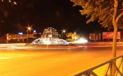 a city street at night with a fountain at Sun & Nature Apartment Corcovada in Albufeira
