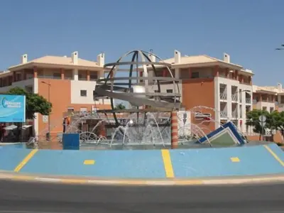 a water park with a water slide in front of a building at Sun & Nature Apartment Corcovada in Albufeira