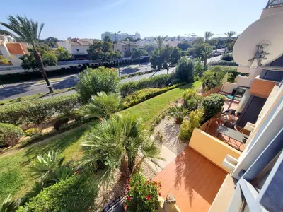 an aerial view of a building with palm trees and a street at Sun & Nature Apartment Corcovada in Albufeira