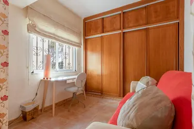 a bedroom with a bed and a desk and a window at Cozy 2 BDR W/Balcony in Vale do Lobo by LovelyStay in Vale do Lobo