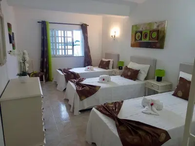 a bedroom with a bed with blue rugs on it at Villa Belavista - Moradia para Famílias in Albufeira