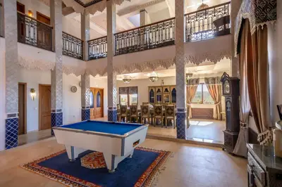 a pool table in the middle of a living room at Al Karob Yoga Boutique Hotel in Guia