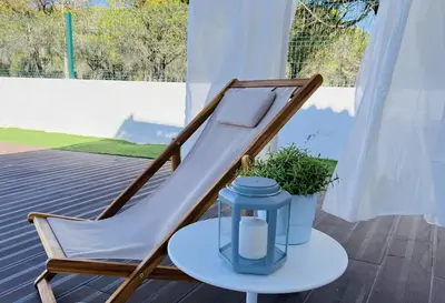 a white table with blue napkins and glasses on it at Villa Amêndoa in Loulé
