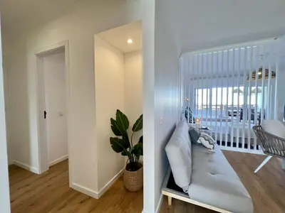 a living room with a mirror and a couch at Vilamoura Marina Charming With Pool by Homing in Vilamoura