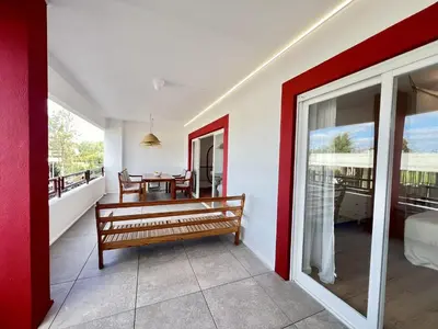 a room with a bench and a table on a balcony at Vilamoura Marina Charming With Pool by Homing in Vilamoura