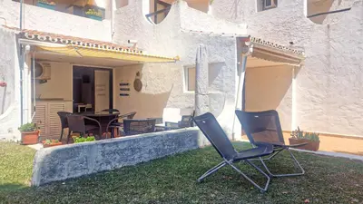 a pair of chairs sitting in the yard of a house at APART ALDEIA DAS AÇOTEIAS - T0 - By BEDZY in Albufeira