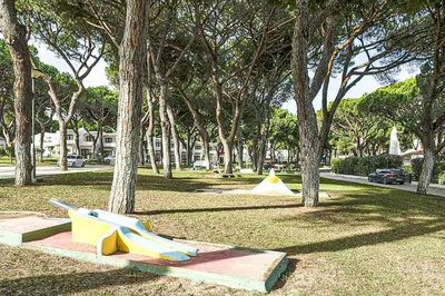 a park with a playground with trees and a slide at APART ALDEIA DAS AÇOTEIAS - T0 - By BEDZY in Albufeira