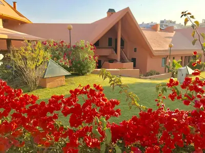 a house with red flowers in front of a yard at Marina Garden by Ethnic Ocean in Vilamoura