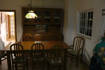a dining room with a wooden table and chairs at Vila Montechoro in Albufeira